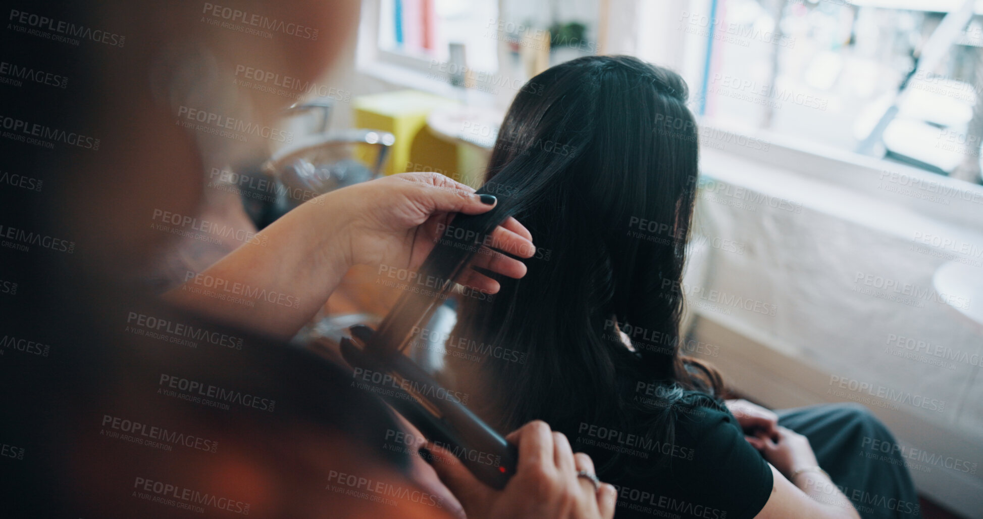 Buy stock photo Hands, hairstylist and flat iron with woman in salon for cosmetology, beauty and grooming. Hairdresser, parlor and customer makeover with people in store for hair care, relax and straightener
