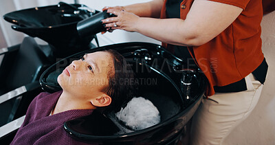 Buy stock photo Hairdresser, customer or child at washing basin at beauty salon, professional service or cleaning scalp. Girl, shampoo treatment or people with stylist for hair care routine, grooming or high angle