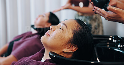 Buy stock photo Relax, hairstylist and washing with woman in salon for cosmetology, beauty and grooming. Hairdresser, parlor and customer makeover with people in store for hair care, rinse and keratin treatment