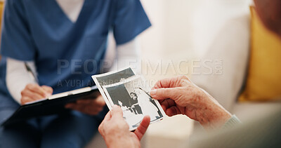 Buy stock photo Home, memory and old woman in lounge, picture and nostalgia with love, wonder and remember. Apartment, nurse and mature person with photography, retirement and mourning death with history or thinking
