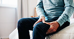 Hands, senior man and leg pain at house from arthritis, parkinson and muscle inflammation. Closeup, elderly person and discomfort of pinched nerve, fibromyalgia and joint cramps from poor circulation