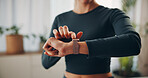 Hands, woman and smart watch in home for fitness, health information and workout progress. Heart rate, person and check wristwatch for wellness stats, monitor pulse or exercise performance with timer