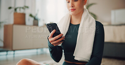 Buy stock photo Hands, phone and texting with exercise in home, break and check notification on fitness app. Woman, smartphone and rest with towel on floor, scroll or tracking progress for training at apartment