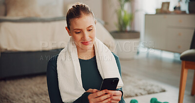 Buy stock photo Woman, phone and texting with exercise in home, break and smile for notification on fitness app. Person, smartphone and happy with scroll, rest or chat on social media with training at apartment