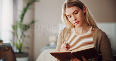 Buy stock photo Student, notebook and reading with woman in home for college assignment due date, research and planning. Schedule, university reminder and journal with person in living room of house for checklist