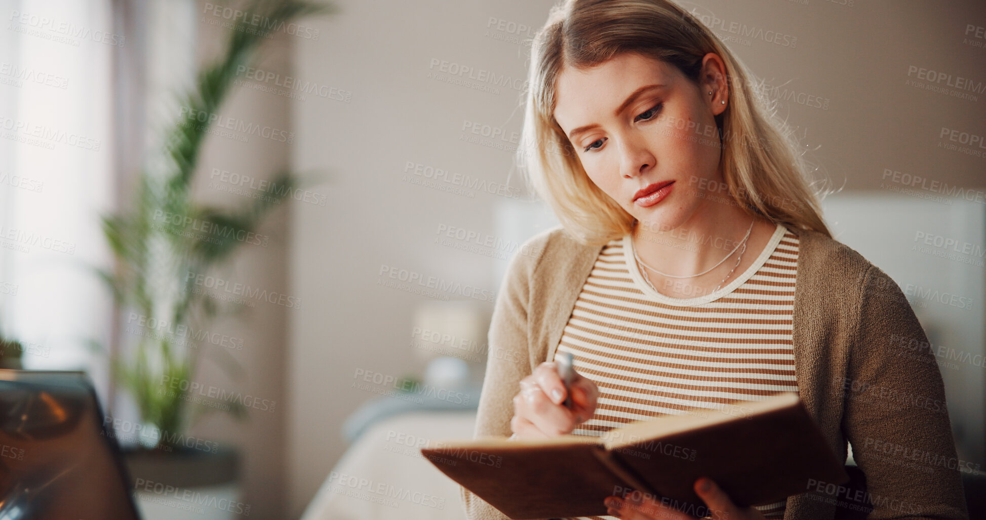Buy stock photo Student, notebook and reading with woman in home for college assignment due date, research and planning. Schedule, university reminder and journal with person in living room of house for checklist