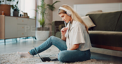 Buy stock photo Student, laptop and thinking with woman in home for assignment research, problem solving and studying. College assessment, brainstorming and headphones with person and tech in living rom of apartment