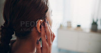 Buy stock photo Hand, woman and touch hearing aid at house with ear device, testing sound and auditory assistance. Back, medical equipment and female person with disability, deaf and audio implant to improve speech