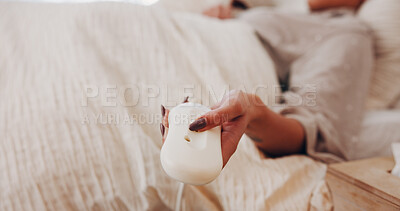 Buy stock photo Electric blanket, remote and hands in house with setting, heat bedding and comfort level in bedsheet. Rest, material and woman in bedroom with tech, thermostat change or cosy in warm comforter.