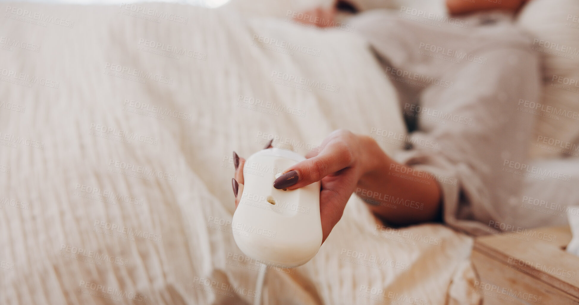 Buy stock photo Electric blanket, remote and hands in house with setting, heat bedding and comfort level in bedsheet. Rest, material and woman in bedroom with tech, thermostat change or cosy in warm comforter.