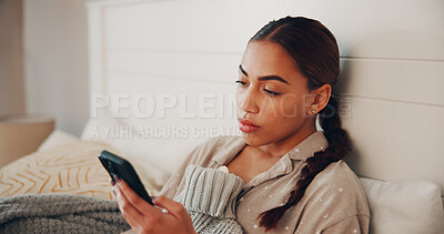 Buy stock photo Phone, hot water bottle and reading of woman in bedroom for pms symptoms, comfort and tension relief. Connection, online cramp remedy and post with person and tech in home for communication and app