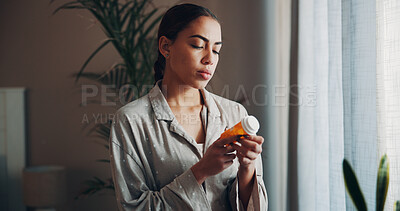 Buy stock photo Home, woman and check pills label in morning for prescription, side effects and dosage info. Apartment, person and reading medication instructions for health benefits, ingredients and tablets warning