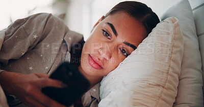 Buy stock photo Woman, phone and texting in bed, home and scroll with chat, check notification or post on web. Person, smartphone and tired with click on mobile app, pyjamas or contact on social network at apartment