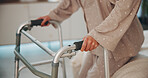 Hands, walker and woman with disability in bedroom for support, mobility aid and surgery recovery. Closeup, female person or medical stroller for walking assistance, injury and rehabilitation in home