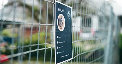 Buy stock photo Adoption, fence and poster of rescue dog outdoor for animal shelter, community or pet ownership. Charity, cage and sign with information on enclosure at pound for activism, attention or welfare