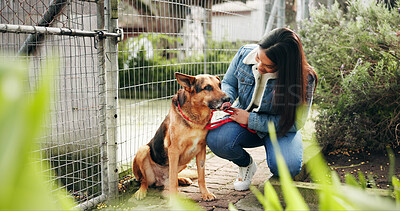Buy stock photo Happy, woman and smile with animal at shelter for adoption service, homeless dogs and rescue centre. Love, girl and puppy by fence for bonding, foster care and pet welfare or charity ngo support
