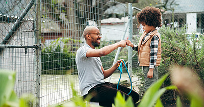 Buy stock photo Animal shelter, fist bump and man with child outdoor for adoption, foster care and learning tips. Kennel, sanctuary and man with kid for teaching responsibility for rescue, pet ownership and welfare
