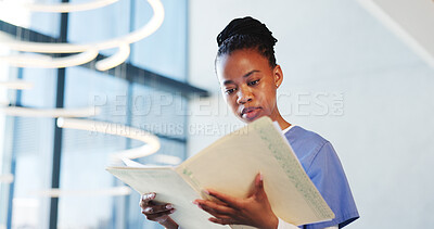 Buy stock photo Nurse, woman and reading in hospital with folder for patient history, medical diagnosis and paperwork. Black person, healthcare worker and check file in clinic for test results, report and document.