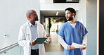 Doctor, tablet and nurse with folder discussion in hospital for medical opinion, update or advice. Health team, men and walking in clinic hallway with treatment feedback, surgery schedule or workflow