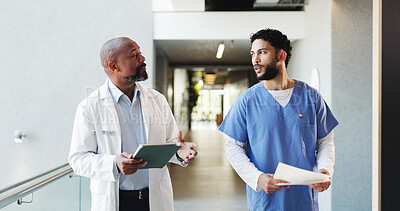 Buy stock photo Doctor, tablet and nurse with folder discussion in hospital for medical opinion, update or advice. Health team, men and walking in clinic hallway with treatment feedback, surgery schedule or workflow