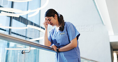 Buy stock photo Nurse, woman and headache of stress in hospital for bad news, treatment fail or regret surgery. Low angle, health professional and anxiety migraine in clinic hallway for patient loss and overwhelmed