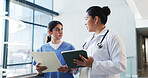 Doctor, tablet and nurse with folder feedback in clinic for treatment solution, opinion or advice. Health team, women and medical records in hospital hallway to explain results or workflow discussion