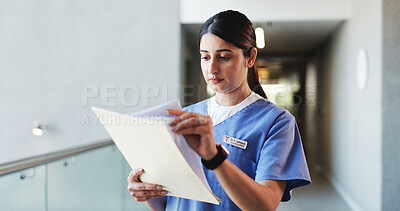 Buy stock photo Doctor, woman and reading in hospital with folder for patient history, medical diagnosis and paperwork. Female person, healthcare worker and check file in clinic for test results, report or document.
