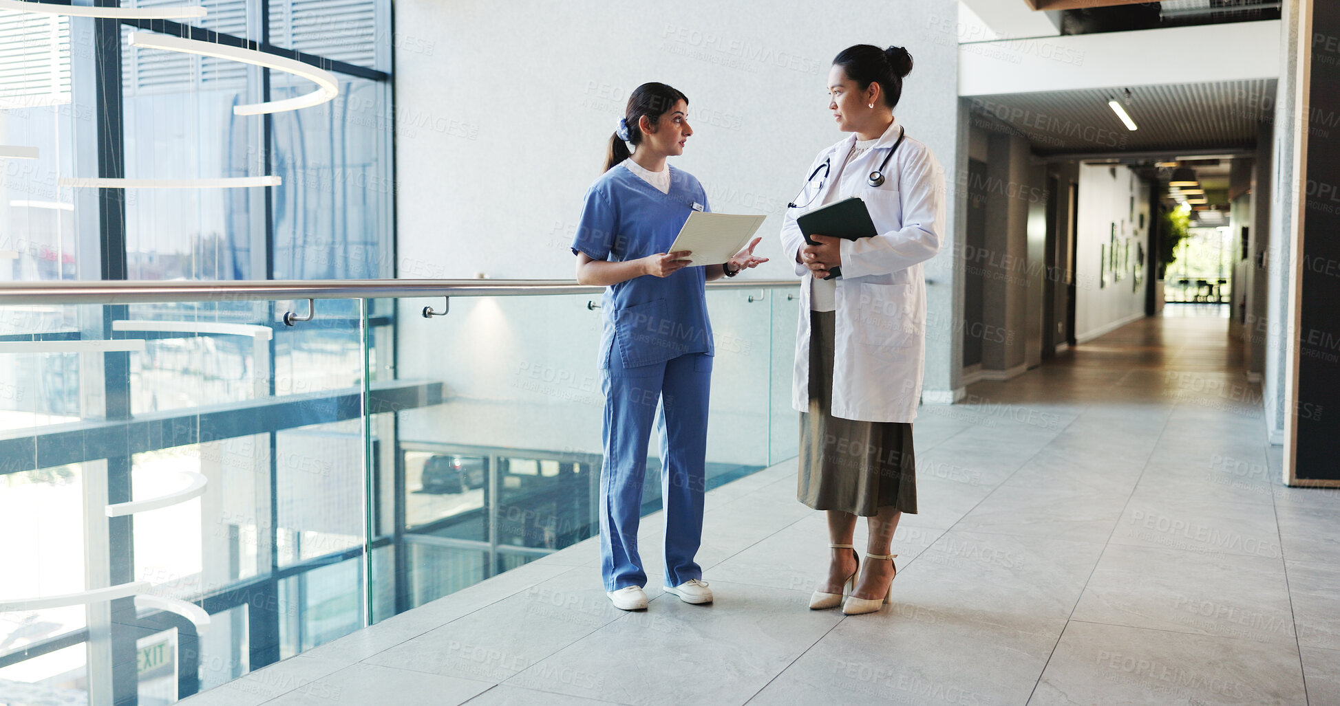 Buy stock photo Doctor, tablet and nurse with folder update in clinic for treatment solution, opinion or advice. Health team, women and medical records in hospital hallway to explain results and workflow discussion