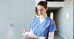 Nurse, glasses and woman with documents, hospital and info for medical diagnosis, serious and report. Reading, patient history and person with paperwork for treatment plan, file or healthcare record