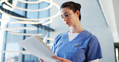 Buy stock photo Nurse, glasses and woman with file, hospital and report for medical diagnosis, serious and documents. Reading, patient history and person with paperwork for treatment plan, healthcare and low angle