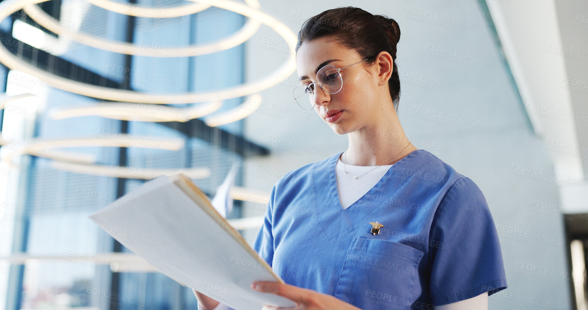 Buy stock photo Nurse, glasses and woman with file, hospital and report for medical diagnosis, serious and documents. Reading, patient history and person with paperwork for treatment plan, healthcare and low angle