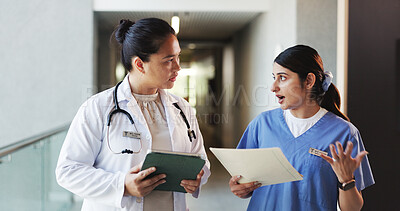 Buy stock photo Doctor, tablet and nurse discussion with file in hospital for medical opinion, update or advice. Health team, women and walking in clinic hallway with treatment feedback, surgery schedule or workflow