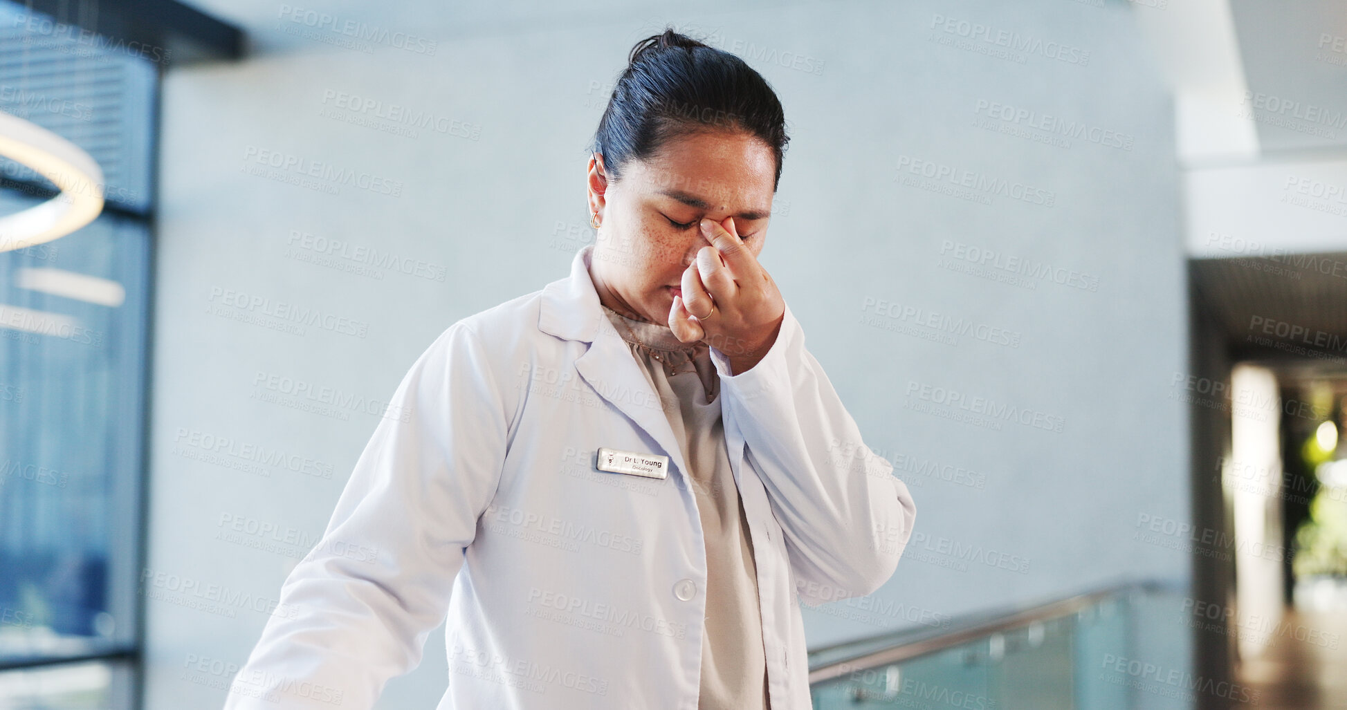 Buy stock photo Doctor, woman and headache of stress in hospital for medical fatigue, overwhelmed or burnout risk. Mental health, professional and tension migraine in clinic for shift exhaustion, overworked or tired