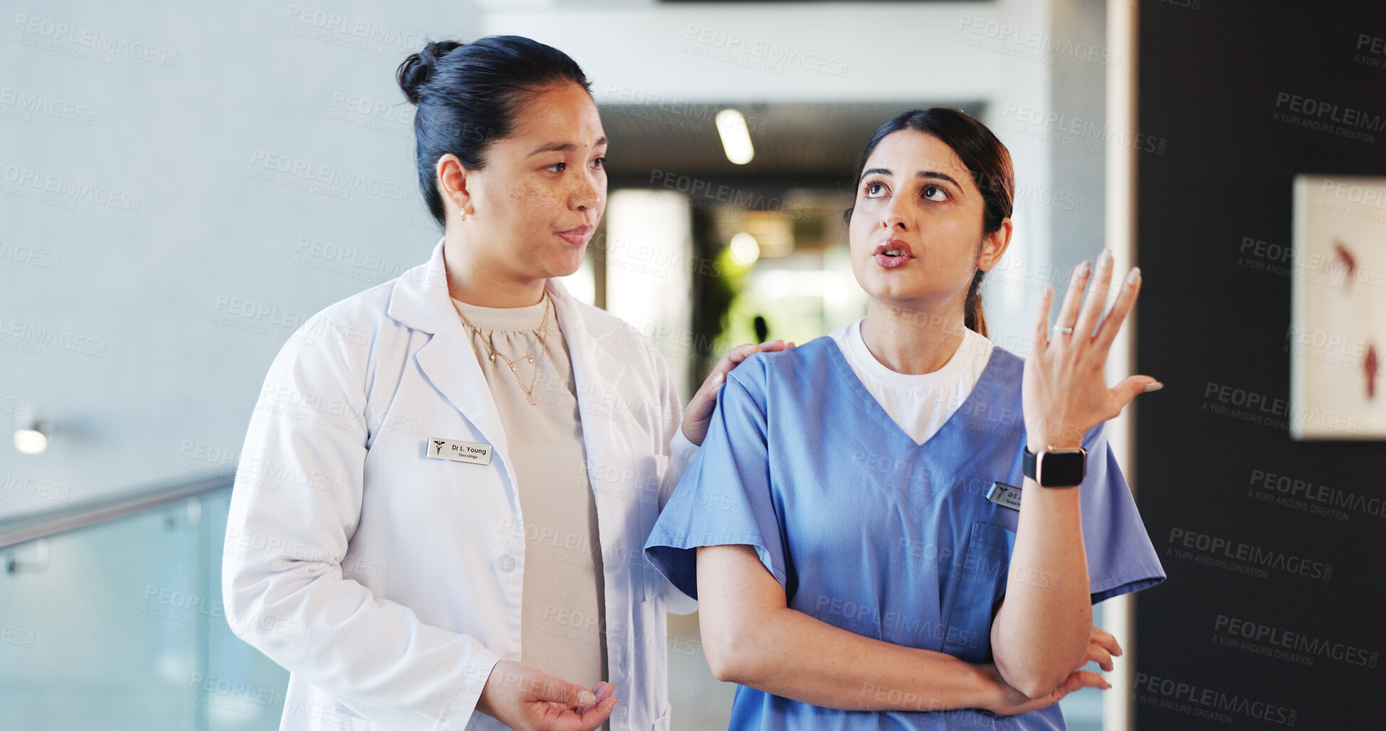 Buy stock photo People, doctors and talking with concern in hospital for staff shortage, treatment delay and mistake. Women, nurse and discussion of medical issues, healthcare malpractice and comfort for reassurance