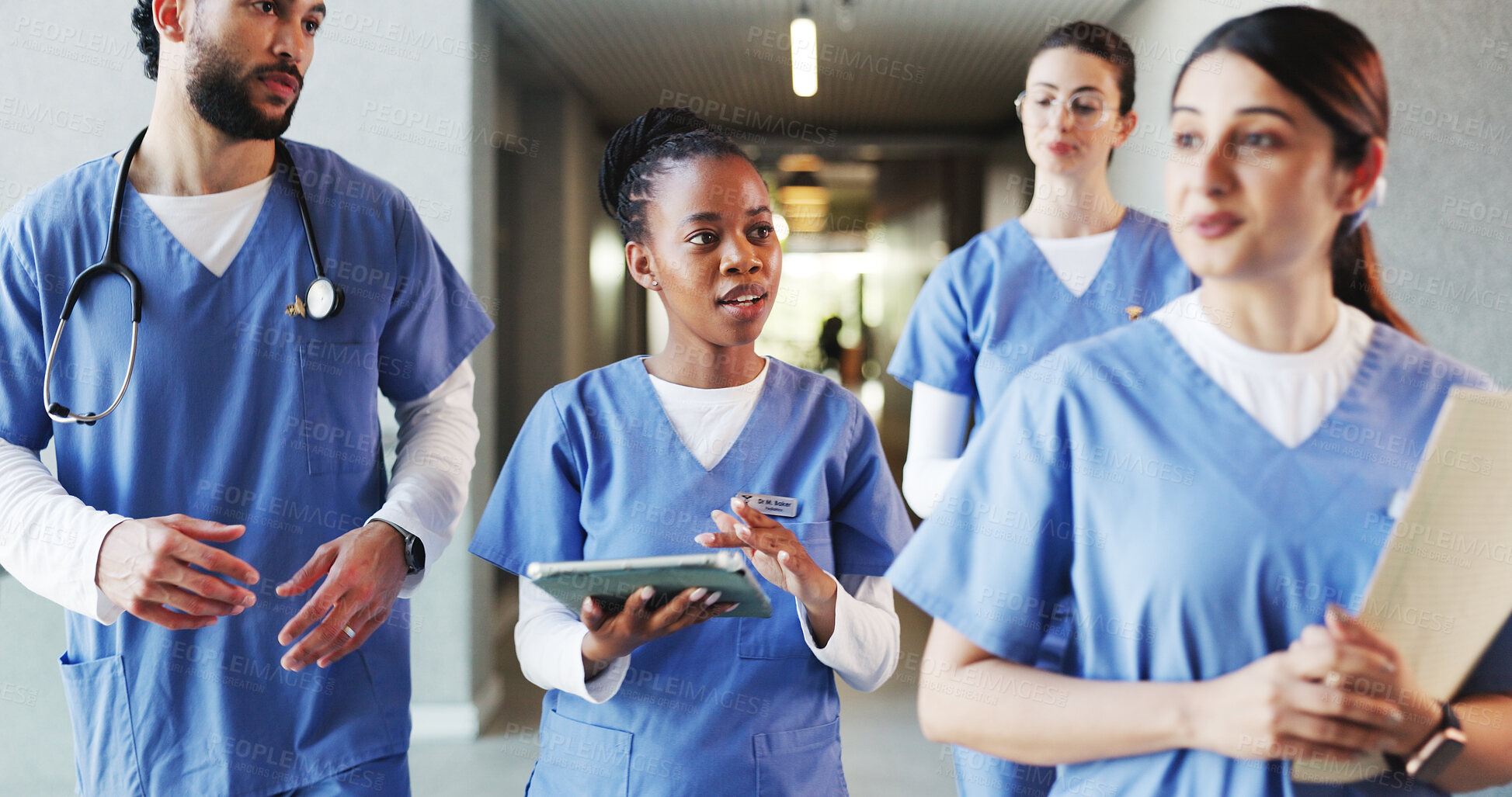 Buy stock photo Walking, hospital and med students on tablet in lobby for consulting, medical advice and diagnosis. Healthcare, doctor internship and people with tech, documents and meeting for results and planning