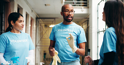 Buy stock photo Shelter, volunteer and people for help with cleaning, hygiene and housekeeping in building. Teamwork, collaboration and man with women talking for ngo charity, outreach program and community service