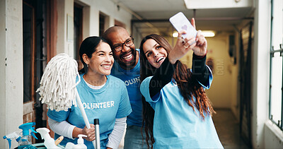 Buy stock photo Shelter, volunteer and people with selfie for cleaning, hygiene and memory for outreach program. Teamwork, happy and man with women with photo, social media and post for charity or community service