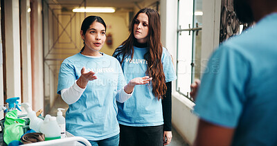 Buy stock photo Talking, volunteer and people in shelter for cleaning, hygiene and housekeeping in building. Team, collaboration and man with women in discussion for charity, outreach program and community service