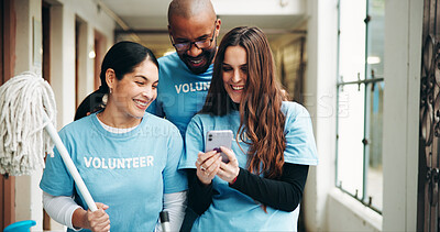 Buy stock photo Shelter, volunteer and people with phone for cleaning, hygiene and help for social media. Teamwork, website and man with women on smartphone for ngo charity, outreach program and community service