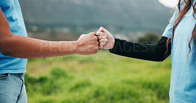 Buy stock photo Volunteer, hands or fist bump in grass field for ngo event, conservation management or green advocate. Monitor nature, support or people with teamwork for wildlife observation, eco project or success