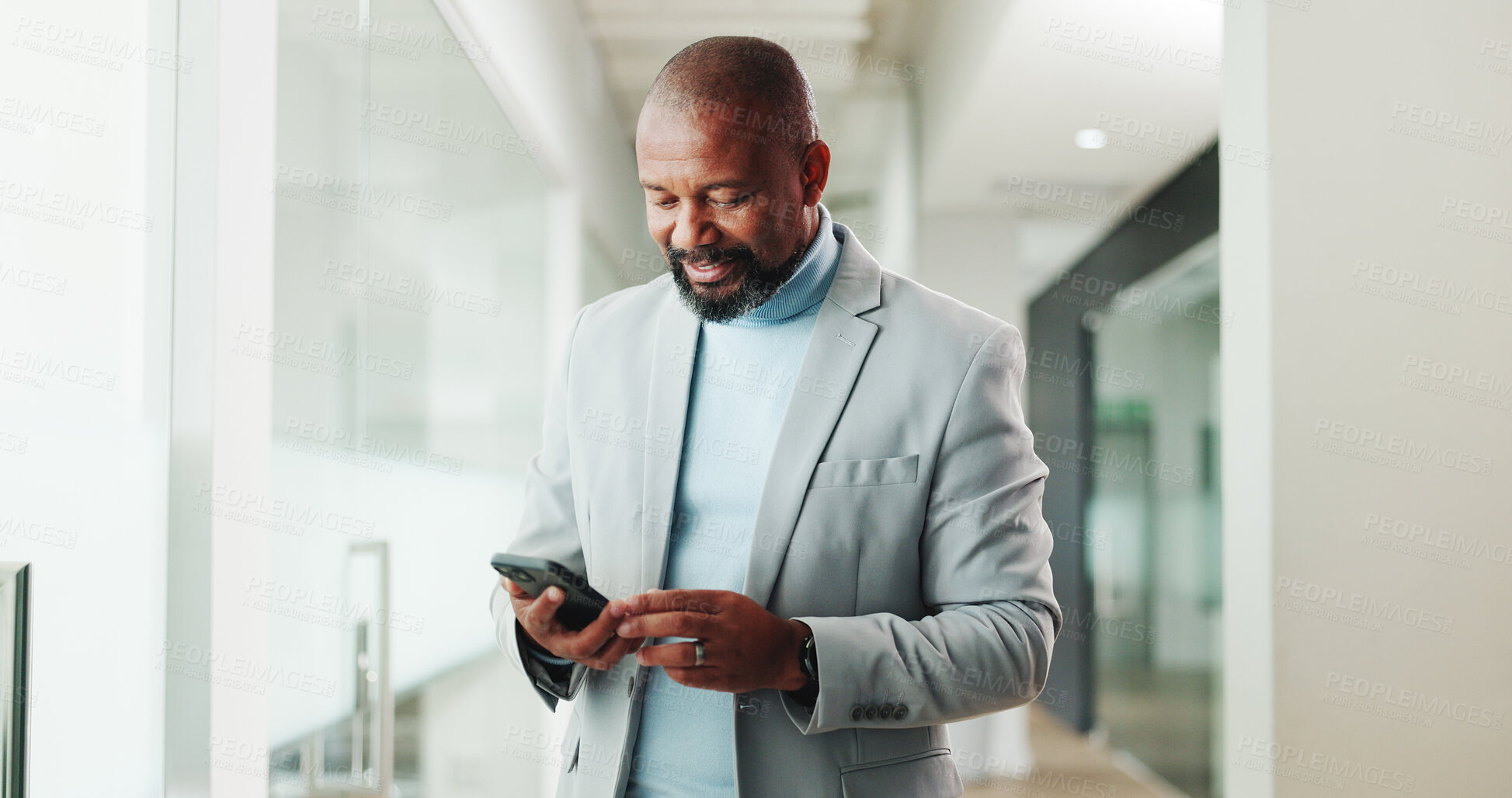 Buy stock photo Happy, businessman and texting with smartphone, hallway and communication with contact on web or app. Typing, message and mature black person with mobile for chat, network and browse on social media
