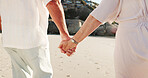 Walking, old couple and holding hands on vacation, beach and bonding on anniversary, love or loyalty. Outdoor, senior people and romance on summer holiday, relationship and commitment for marriage