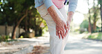 Senior woman, hands and fitness with knee injury for accident, emergency or pain in road. Elderly, female person or leg with ache, sprain or bone for muscle tension, fibromyalgia or bruise in street