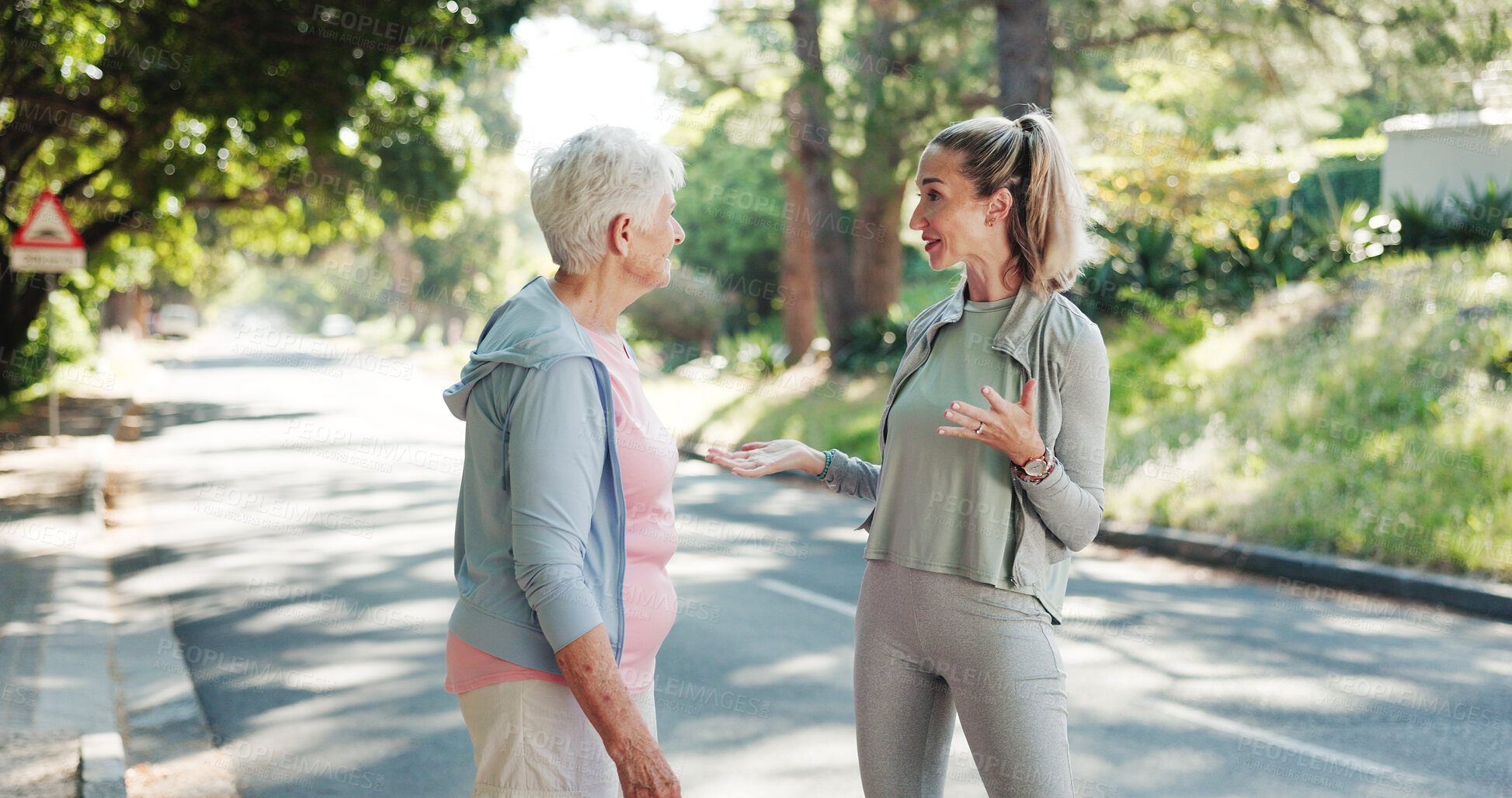 Buy stock photo Senior, women or discussion with personal trainer in road for workout routine or exercise together. Elderly, female people or coach explaining tips for outdoor training, health or wellness in street