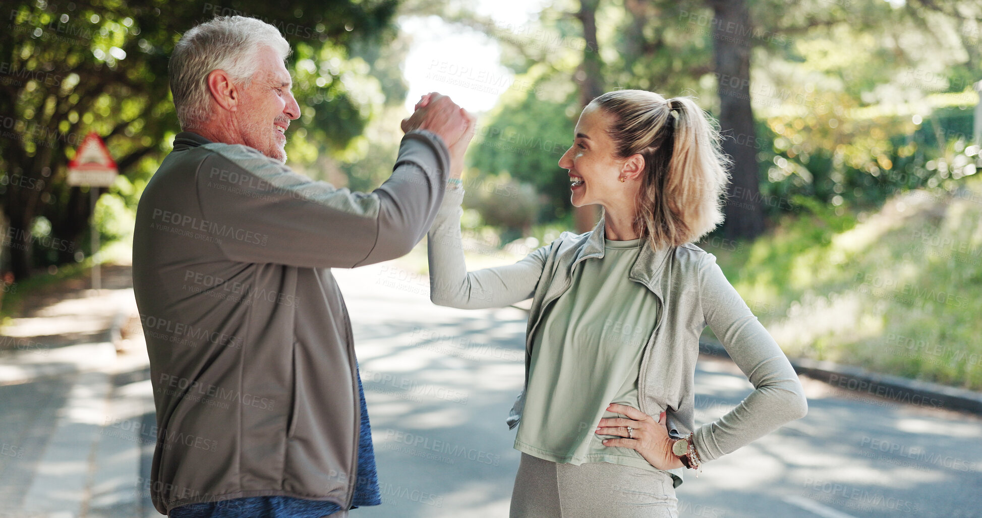 Buy stock photo Senior man, personal trainer and fitness with success in road for achievement, workout or exercise. Elderly, male person or coach with smile, handshake or high five for winning or physical activity