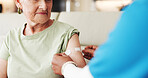 Caregiver, old woman and arm in nursing home with bandage for flu vaccine, healthcare and wellness. Nurse, elderly person and help with immunity shot plaster, medical safety or protection from virus.