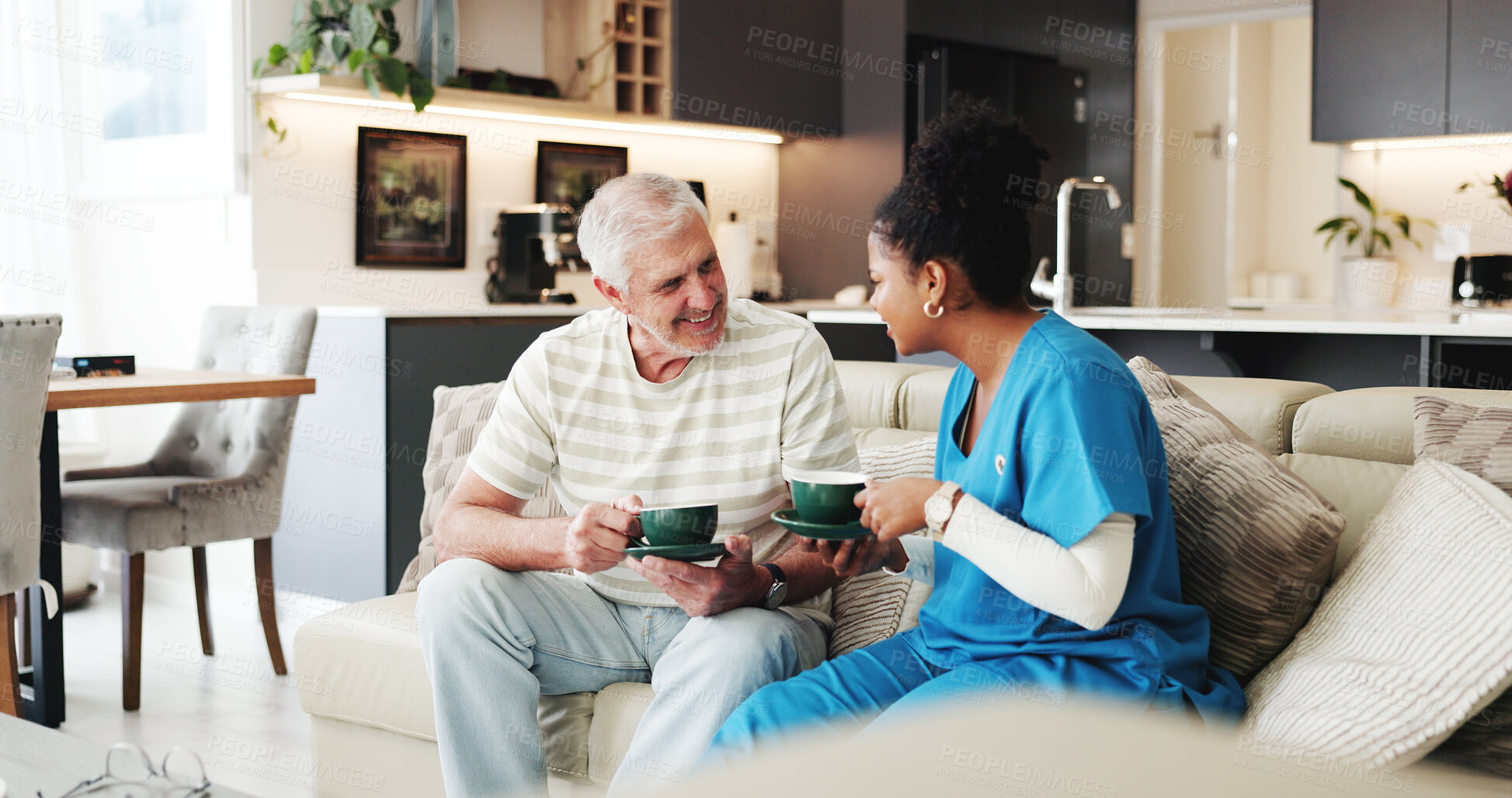 Buy stock photo Coffee, healthcare or visit with nurse and old man on sofa in living room of home together. Caffeine, conversation or wellness with medical caregiver and senior patient drinking beverage in apartment