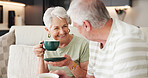 Coffee, laughing and retirement with old couple on sofa in living room of home together for break. Conversation, bonding and funny with senior people drinking beverage in apartment for wellness