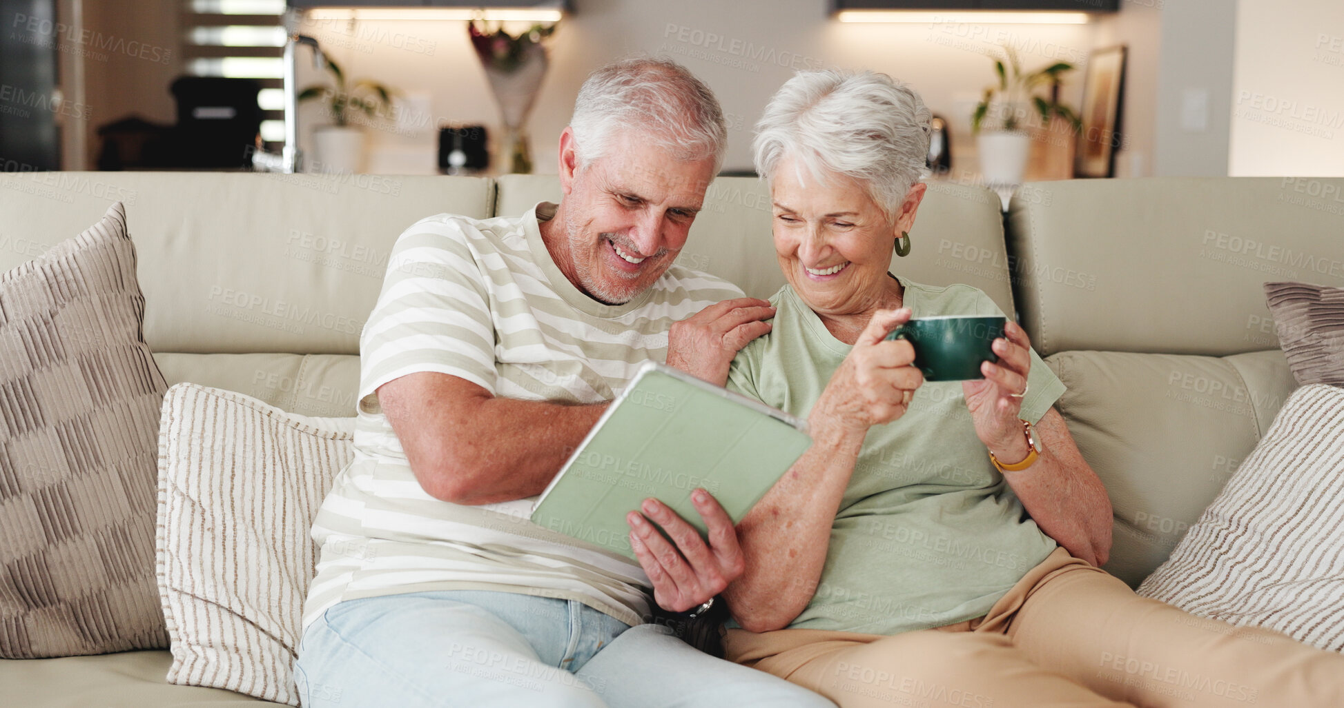 Buy stock photo Coffee, laughing and tablet with old couple on sofa in living room of home together for break. Bonding, funny and streaming app with happy senior people drinking beverage in apartment for wellness