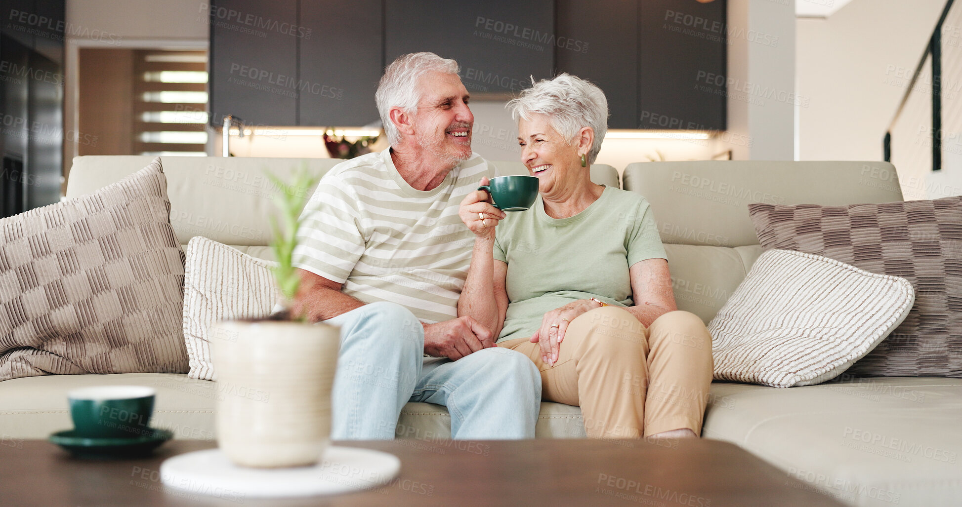 Buy stock photo Coffee, laughing and retirement with senior couple on sofa in living room of home together for break. Conversation, bonding and funny with old people drinking beverage in apartment for wellness